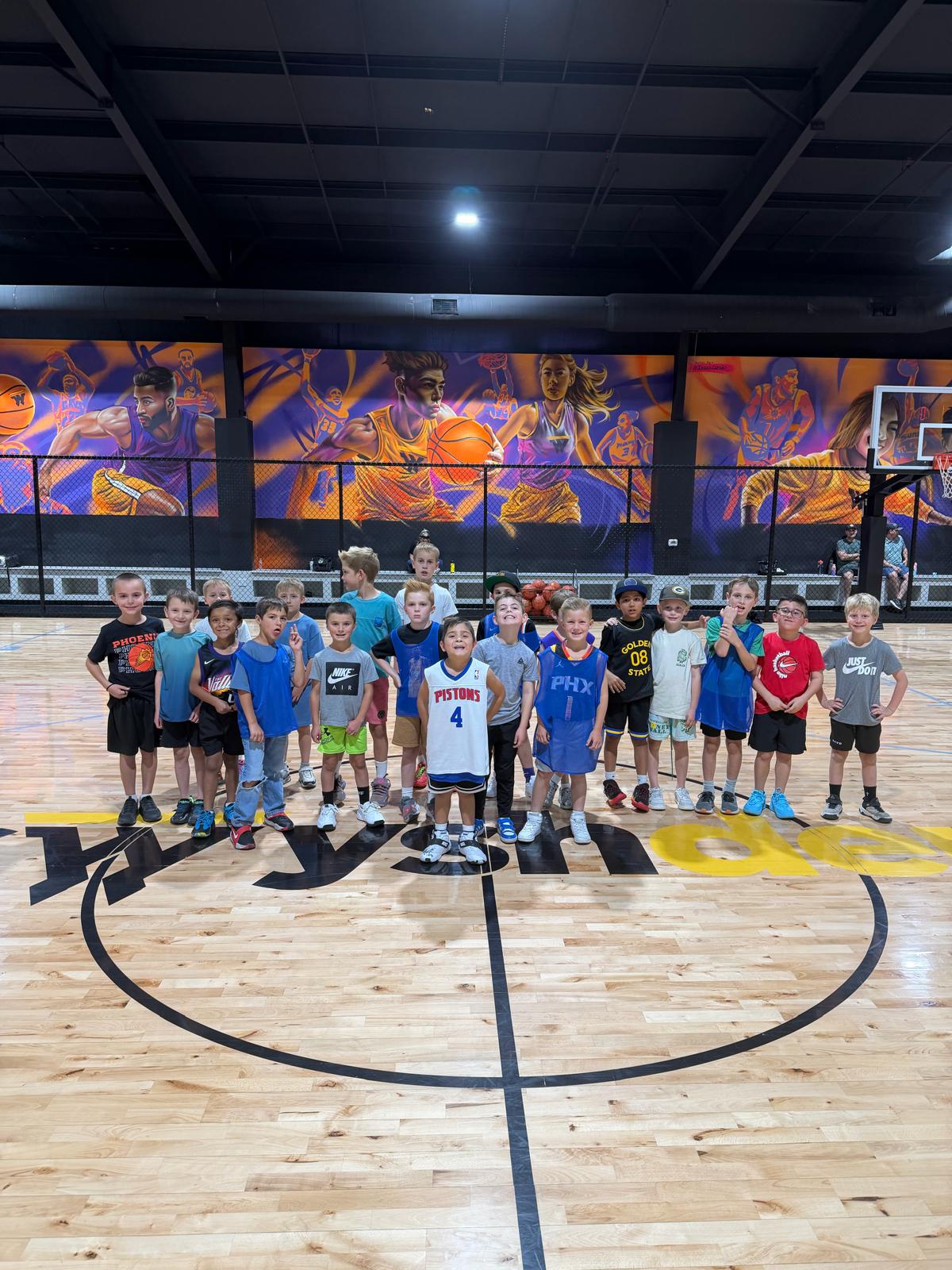 A large group of kids gathered on the court at Swysh Den during a birthday party