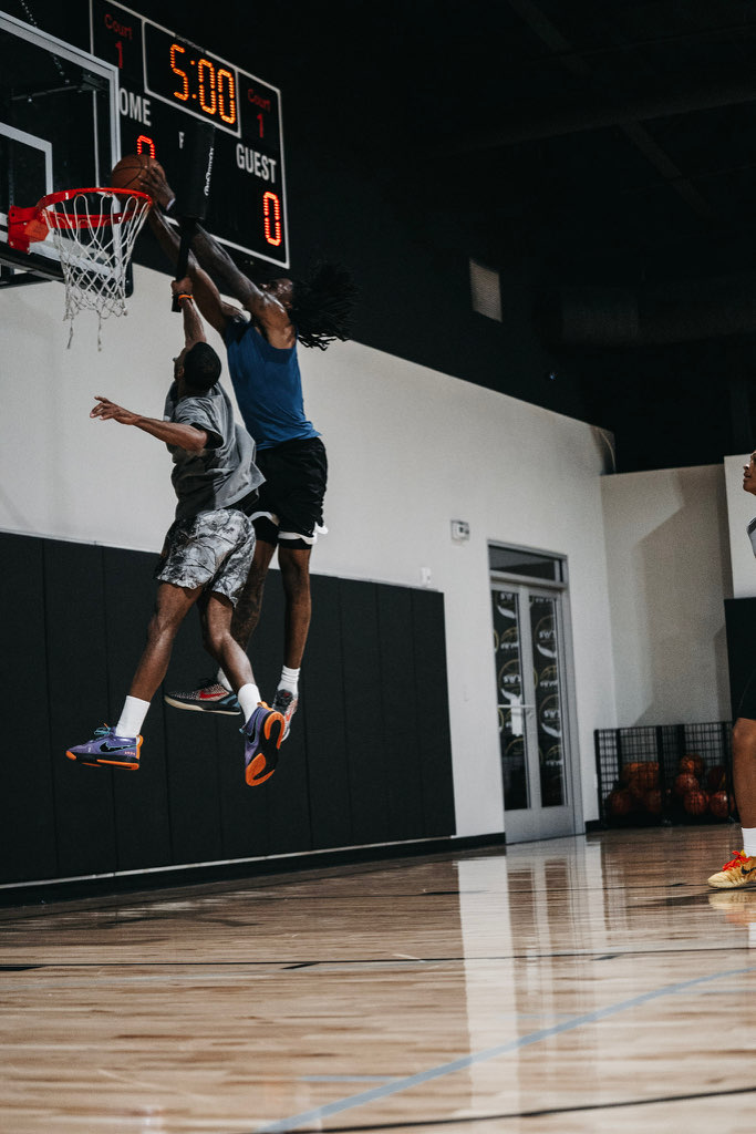 Two Swysh Flight School players contesting at the rim