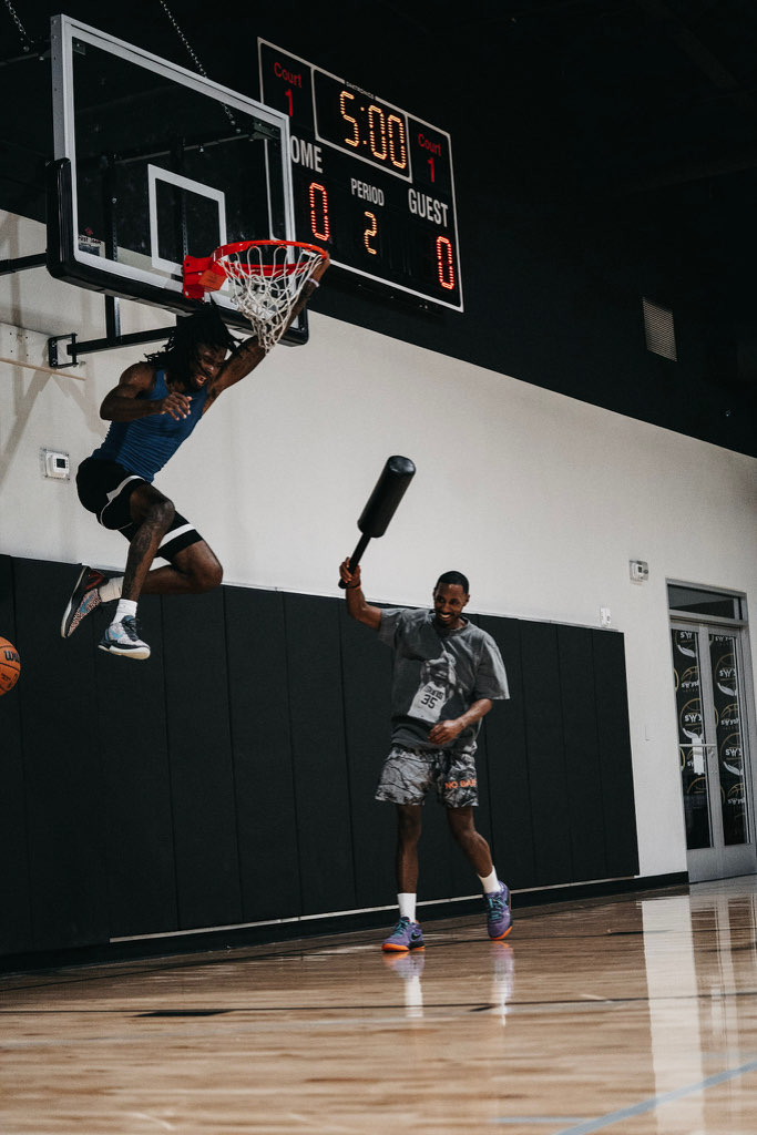 A Swysh Flight School player skying for a dunk past a contest bar