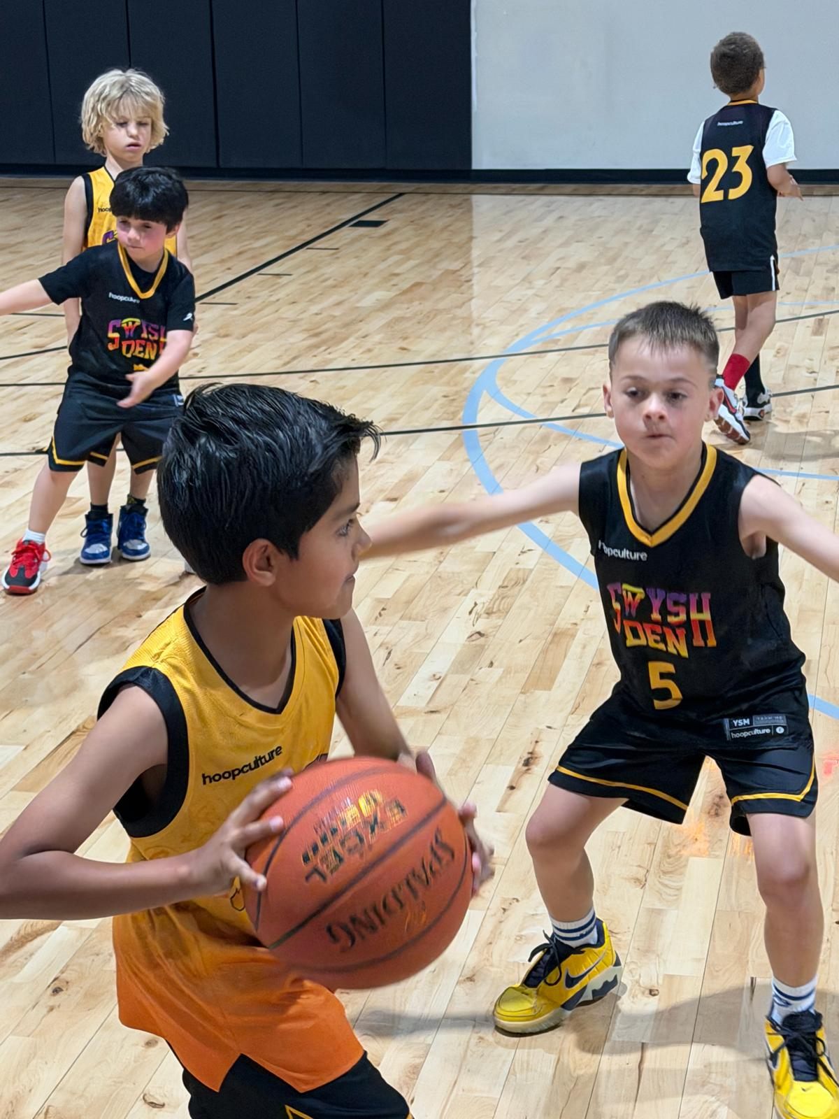 A Swysh Den player drives past a defender during a league game